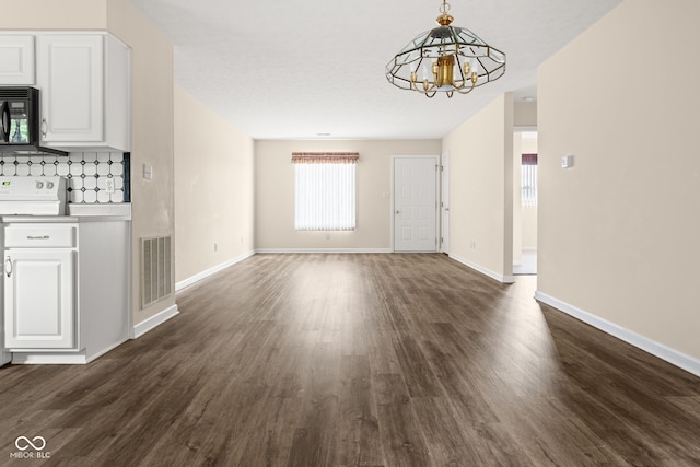 1309 Wyoming Way, Anderson, IN 46013 - unfurnished living room featuring a chandelier and dark wood-type flooring