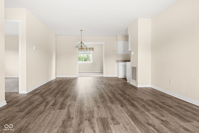 1309 Wyoming Way, Anderson, IN 46013 - unfurnished living room with a chandelier and dark wood-style flooring
