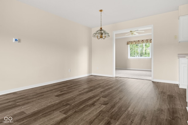1309 Wyoming Way, Anderson, IN 46013 - unfurnished dining area with dark wood finished floors, ceiling fan, and a chandelier