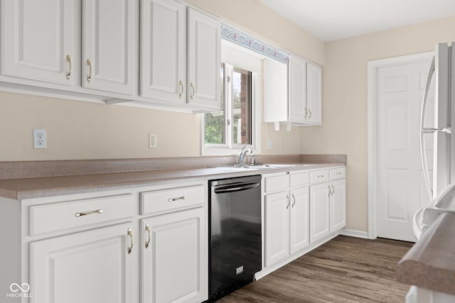 1309 Wyoming Way, Anderson, IN 46013 - kitchen with dishwasher, white cabinets, dark wood finished floors, freestanding refrigerator, and light countertops