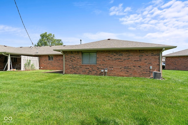 1309 Wyoming Way, Anderson, IN 46013 - rear view of house with brick siding, a yard, and a shingled roof