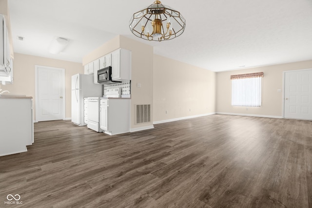 1309 Wyoming Way, Anderson, IN 46013 - unfurnished living room featuring a chandelier and dark wood finished floors