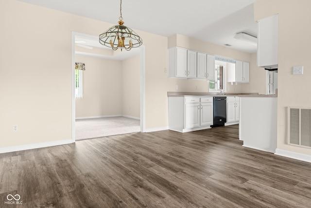 1309 Wyoming Way, Anderson, IN 46013 - unfurnished living room with dark wood-style floors, healthy amount of natural light, and a chandelier