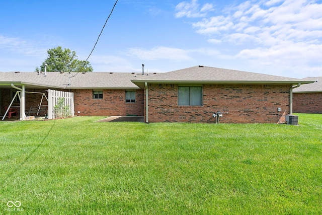 1309 Wyoming Way, Anderson, IN 46013 - rear view of house featuring brick siding, a lawn, and a shingled roof