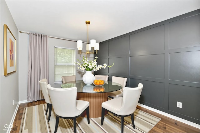5759 Columbia Cir S, Greenwood, IN 46142 - dining space featuring a chandelier, a decorative wall, and wood finished floors