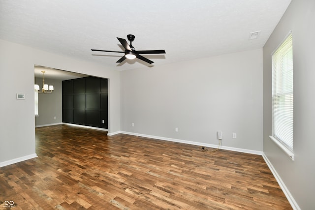 5759 Columbia Cir S, Greenwood, IN 46142 - empty room with wood finished floors, a chandelier, and ceiling fan