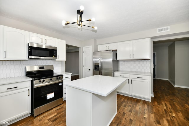 5759 Columbia Cir S, Greenwood, IN 46142 - kitchen with appliances with stainless steel finishes, a chandelier, decorative backsplash, and white cabinetry