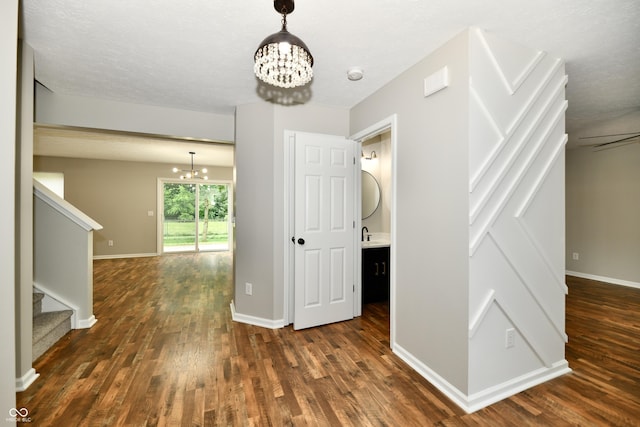 5759 Columbia Cir S, Greenwood, IN 46142 - corridor with a chandelier, dark wood finished floors, and stairs