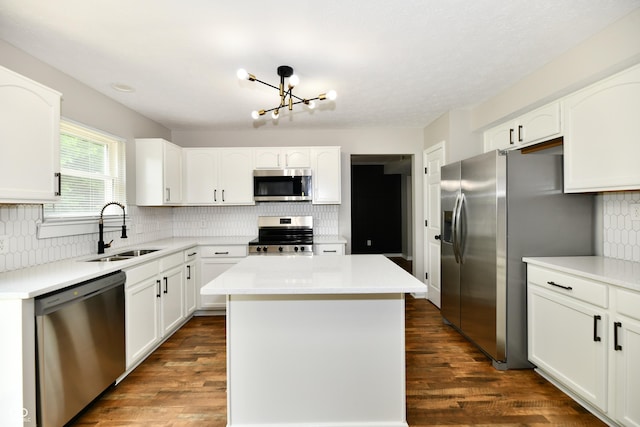 5759 Columbia Cir S, Greenwood, IN 46142 - kitchen featuring appliances with stainless steel finishes, tasteful backsplash, a kitchen island, and white cabinetry