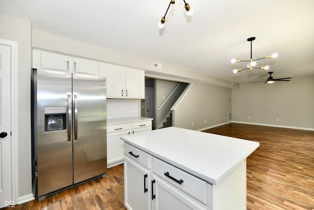 5759 Columbia Cir S, Greenwood, IN 46142 - kitchen featuring stainless steel refrigerator with ice dispenser, dark wood finished floors, white cabinets, light countertops, and a chandelier