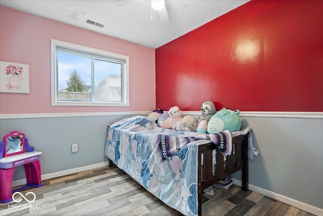 6120 E Southport Rd, Indianapolis, IN 46237 - bedroom with wood finished floors, a ceiling fan, and a textured ceiling