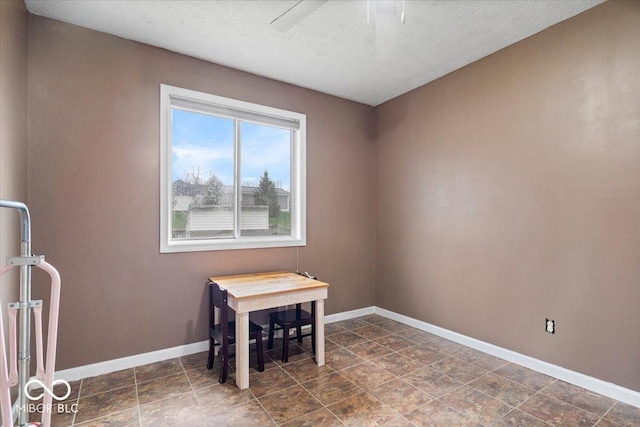 6120 E Southport Rd, Indianapolis, IN 46237 - empty room with a textured ceiling, a ceiling fan, and dark stone finish floors