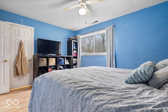 6120 E Southport Rd, Indianapolis, IN 46237 - bedroom featuring wood finished floors, a ceiling fan, and a textured ceiling