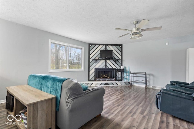 6120 E Southport Rd, Indianapolis, IN 46237 - living area featuring a textured ceiling, wood finished floors, ceiling fan, and a fireplace