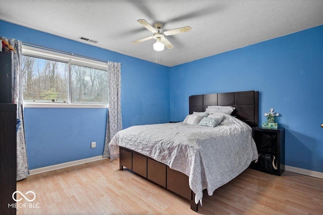 6120 E Southport Rd, Indianapolis, IN 46237 - bedroom with wood finished floors, ceiling fan, and a textured ceiling