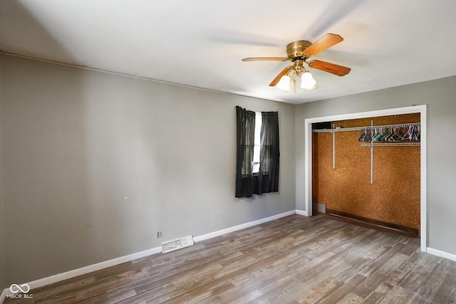 13041 S Finer St, Pimento, IN 47866 - unfurnished bedroom featuring wood finished floors, a closet, and a ceiling fan