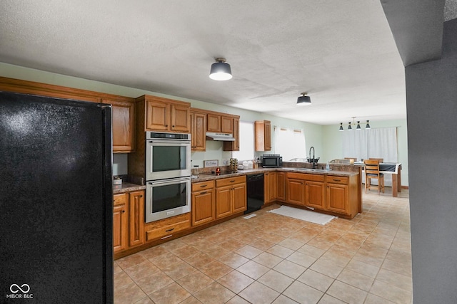 13041 S Finer St, Pimento, IN 47866 - kitchen featuring black appliances, a peninsula, brown cabinets, light tile patterned flooring, and under cabinet range hood