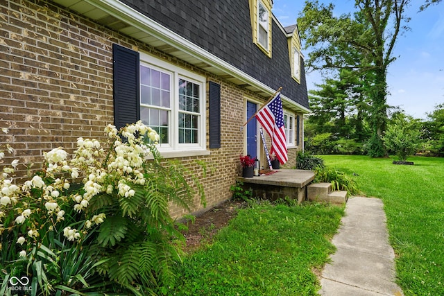13041 S Finer St, Pimento, IN 47866 - view of property exterior featuring mansard roof, a shingled roof, brick siding, and a yard