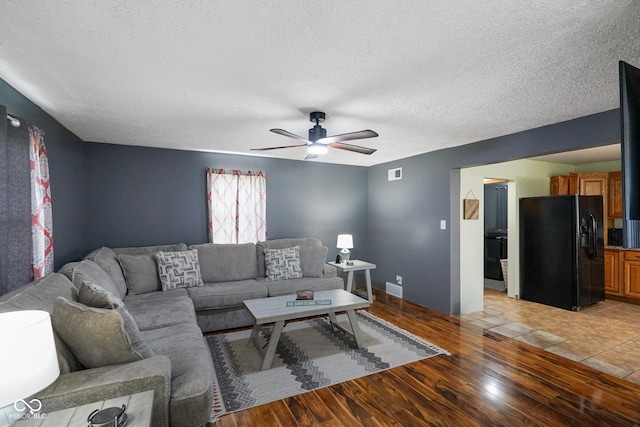 13041 S Finer St, Pimento, IN 47866 - living area featuring light wood finished floors, ceiling fan, and a textured ceiling