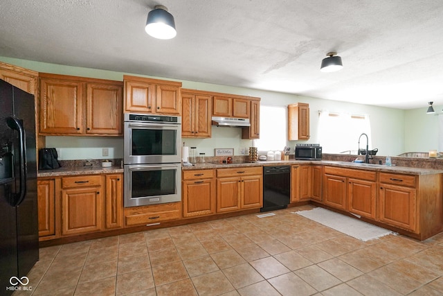 13041 S Finer St, Pimento, IN 47866 - kitchen featuring black appliances, under cabinet range hood, a peninsula, brown cabinets, and a textured ceiling