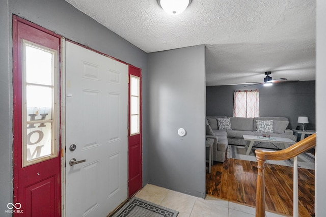 13041 S Finer St, Pimento, IN 47866 - entrance foyer featuring light tile patterned floors, a textured ceiling, and a ceiling fan