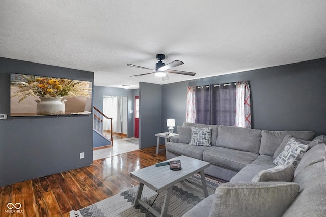 13041 S Finer St, Pimento, IN 47866 - living area featuring wood finished floors, stairway, a ceiling fan, and a textured ceiling