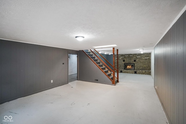 13041 S Finer St, Pimento, IN 47866 - finished below grade area with a fireplace, stairs, a textured ceiling, and wood walls