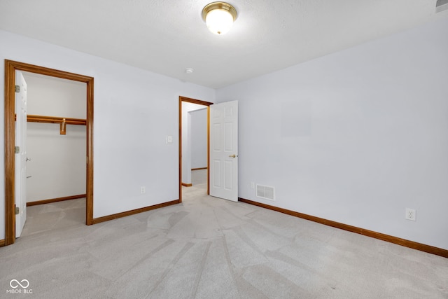9735 Woodsong Ln, Indianapolis, IN 46229 - unfurnished bedroom with carpet, a spacious closet, and a closet