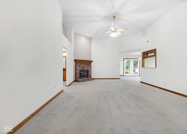 9735 Woodsong Ln, Indianapolis, IN 46229 - unfurnished living room with a fireplace, light colored carpet, a ceiling fan, a high ceiling, and recessed lighting