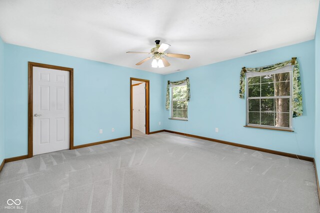9735 Woodsong Ln, Indianapolis, IN 46229 - unfurnished bedroom featuring light carpet and ceiling fan