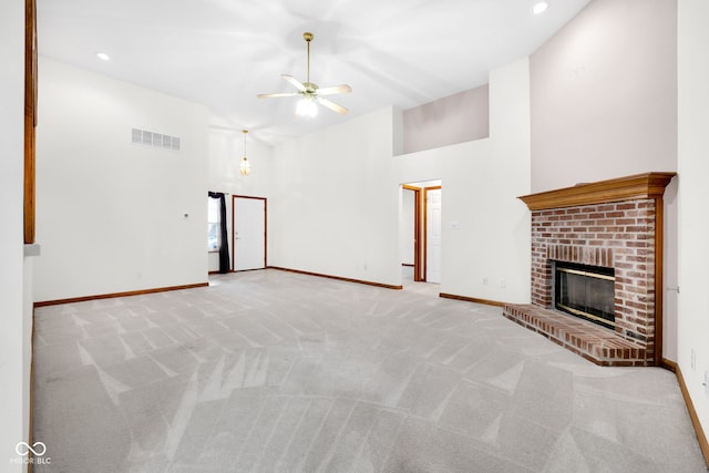 9735 Woodsong Ln, Indianapolis, IN 46229 - unfurnished living room featuring a high ceiling, a ceiling fan, a brick fireplace, light carpet, and recessed lighting