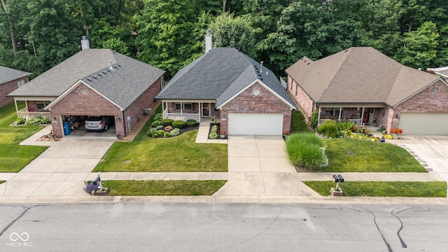 9735 Woodsong Ln, Indianapolis, IN 46229 - view of front of house with a porch, brick siding, and concrete driveway