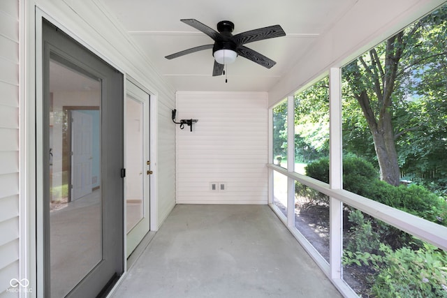 9735 Woodsong Ln, Indianapolis, IN 46229 - unfurnished sunroom featuring ceiling fan, concrete floors, and wood walls