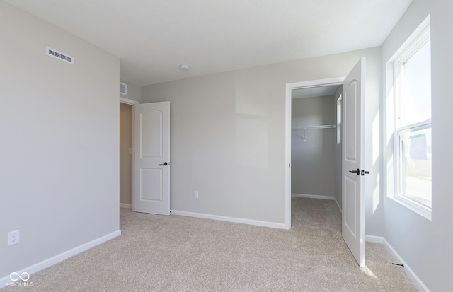 9737 Oleander Dr, Fishers, IN 46250 - unfurnished bedroom with light carpet, a walk in closet, and a closet
