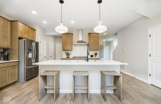 9737 Oleander Dr, Fishers, IN 46250 - kitchen with wall chimney exhaust hood, stainless steel refrigerator with ice dispenser, backsplash, light wood finished floors, and recessed lighting