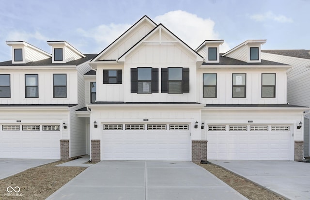 9737 Oleander Dr, Fishers, IN 46250 - view of property featuring board and batten siding, a garage, brick siding, and concrete driveway