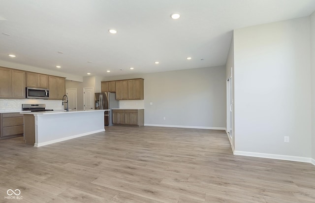 9737 Oleander Dr, Fishers, IN 46250 - kitchen featuring stainless steel appliances, recessed lighting, light wood finished floors, open floor plan, and decorative backsplash