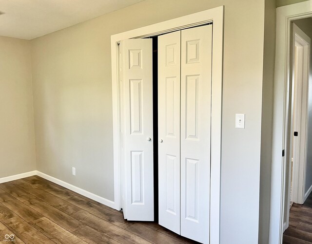 15841 E 265 N, Columbus, IN 47203 - unfurnished bedroom featuring dark wood-style floors and a closet