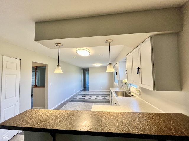 15841 E 265 N, Columbus, IN 47203 - kitchen featuring white cabinets, hanging light fixtures, and dark countertops