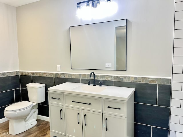 15841 E 265 N, Columbus, IN 47203 - bathroom with tile walls, wood finished floors, vanity, and a wainscoted wall