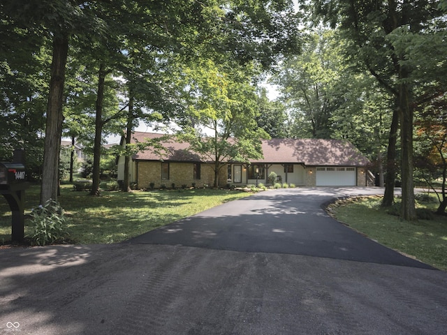 14407 Bryn Mawr Dr, Fishers, IN 46038 - view of front facade featuring asphalt driveway, a front yard, an attached garage, and stone siding