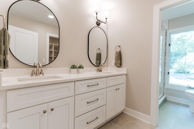 14407 Bryn Mawr Dr, Fishers, IN 46038 - bathroom featuring double vanity, tile patterned floors, a shower with shower door, and recessed lighting