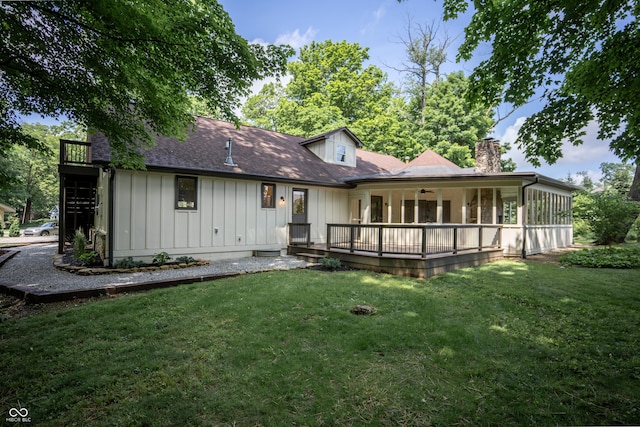 14407 Bryn Mawr Dr, Fishers, IN 46038 - rear view of property with board and batten siding, a chimney, a lawn, and ceiling fan