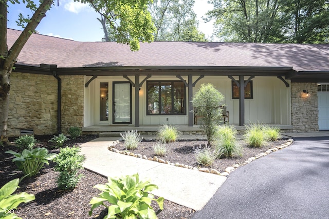 14407 Bryn Mawr Dr, Fishers, IN 46038 - entrance to property featuring a porch, stone siding, and roof with shingles