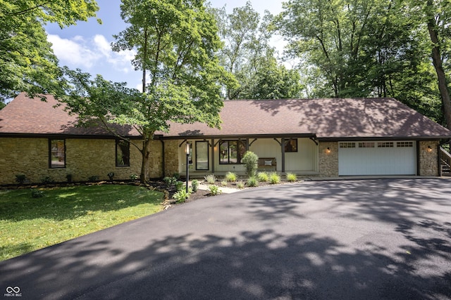 14407 Bryn Mawr Dr, Fishers, IN 46038 - view of front facade featuring stone siding, asphalt driveway, a garage, and roof with shingles