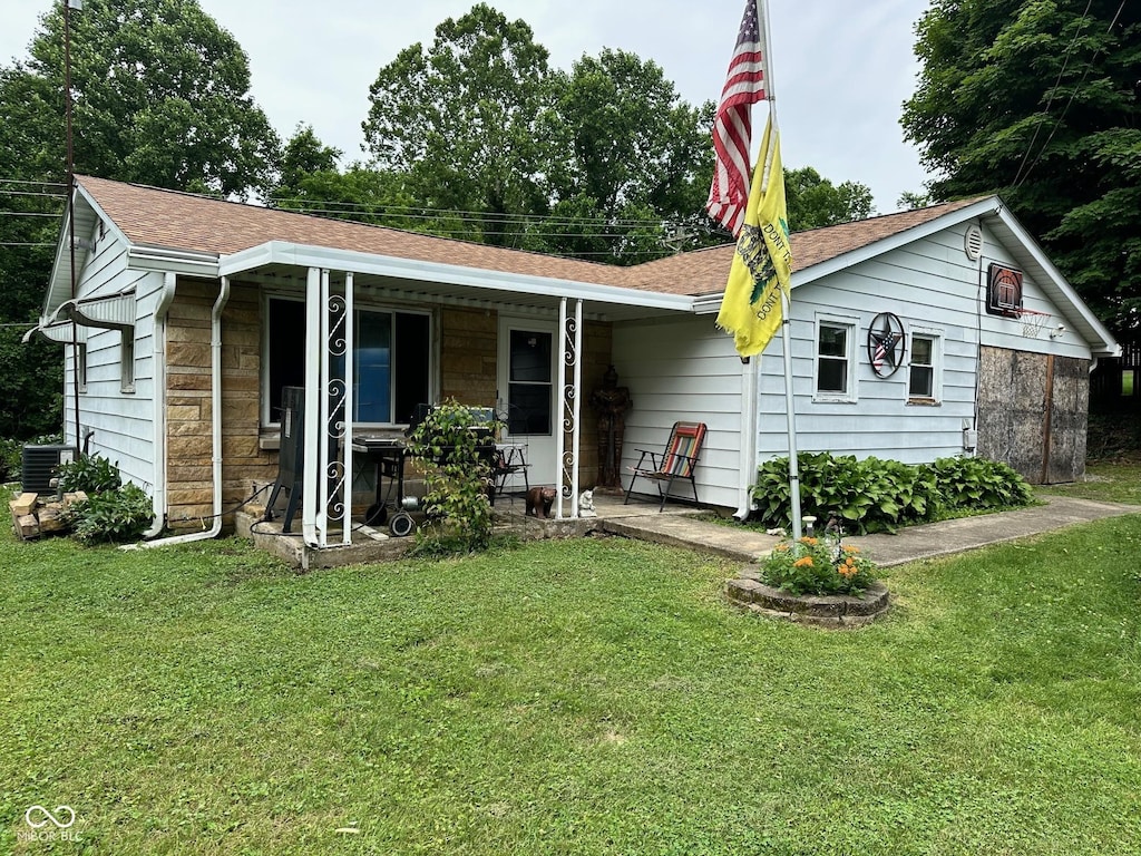 1165 Freeman Rd, Spencer, IN 47460 - ranch-style house featuring a front lawn, covered porch, stone siding, and a shingled roof