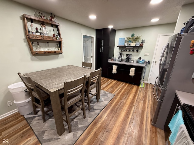 1816 Hemlock Ln, Plainfield, IN 46168 - dining area with a bar, light wood-style flooring, and recessed lighting