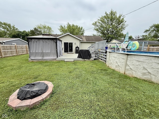 1816 Hemlock Ln, Plainfield, IN 46168 - rear view of property with a fire pit and a deck