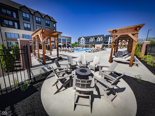 9751 Behner Dr, Fishers, IN 46250 - view of patio featuring an outdoor fire pit, a pergola, and a community pool