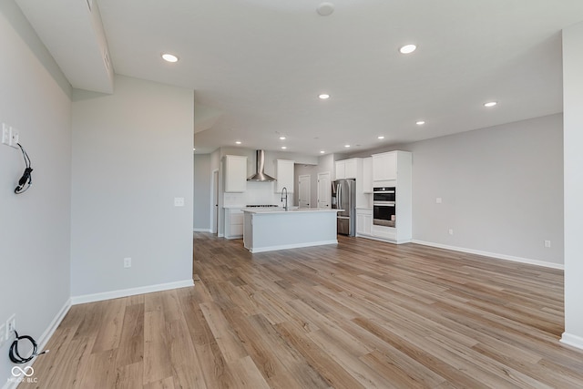 9751 Behner Dr, Fishers, IN 46250 - unfurnished living room with light wood finished floors and recessed lighting